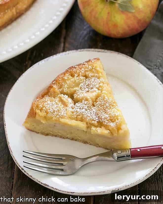 An inviting overhead view of a slice of French apple cake, showcasing its rich texture and abundant apple chunks.
