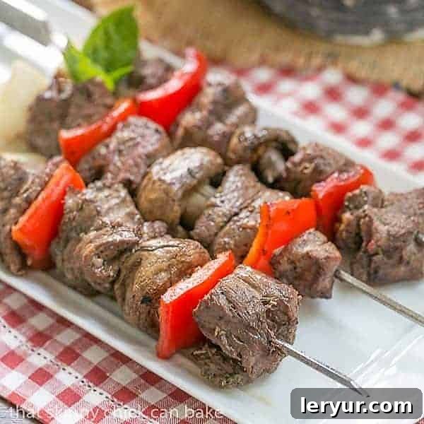 Tender Grilled Beef Steak Kabobs with a simple, flavor packed marinade Tender Skewered Grilled Beef Steak Kabobs on a white tray
