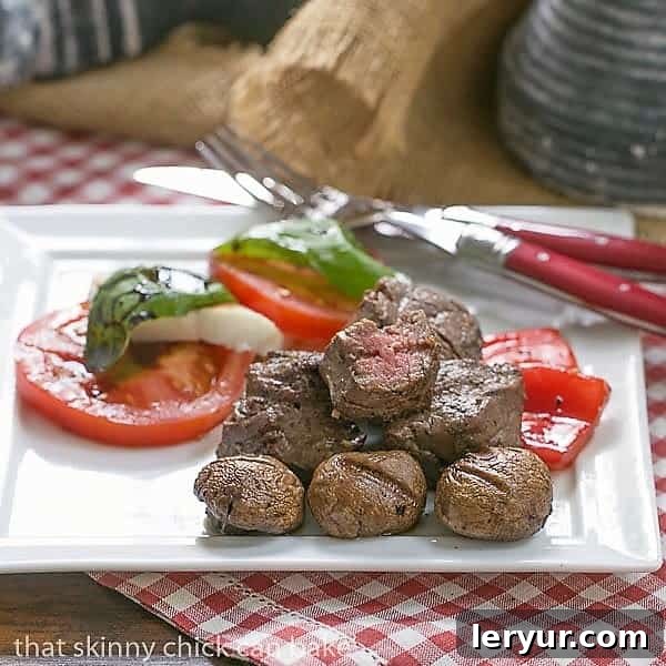 Tender Grilled Beef Steak Kabobs with a simple, flavor packed marinade Tender Beef Steak Kabobs on a white plate