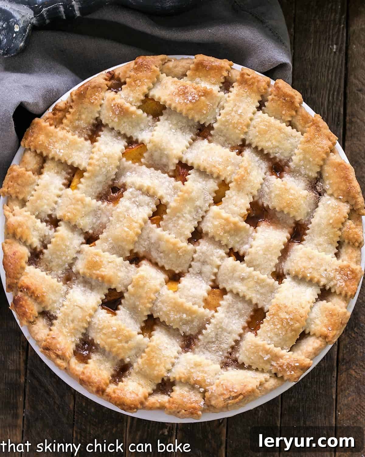Classic Peach Pie - A flaky lattice crust topping sweet and juicy peach filling Overhead view of a Classic Peach Pie with a lattice crust.
