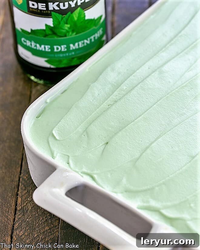 Emerald Mint Velvet Cake 2 Full Creme de Menthe Cake in a white ceramic baking dish, showing its luscious layers before slicing.