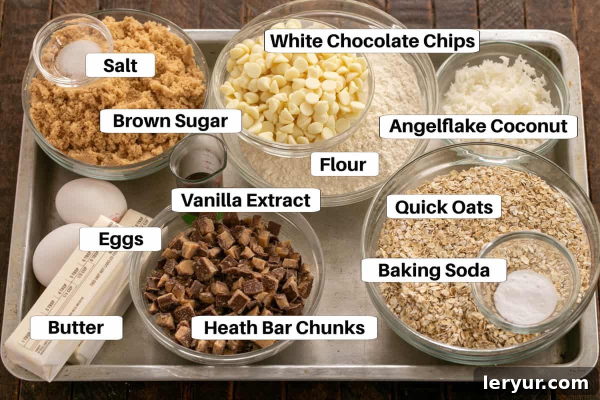 Chewy Oatmeal Caramel Delights 2 An overhead shot showcasing all the essential ingredients for delicious Oatmeal Toffee Cookies, neatly arranged and labeled on a sleek metal sheet pan, ready for mixing.