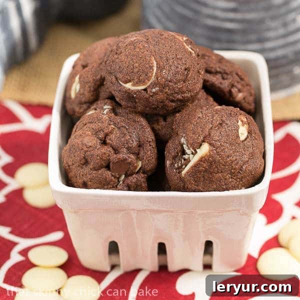 Triple chocolate chip cookies in a white ceramic basket.