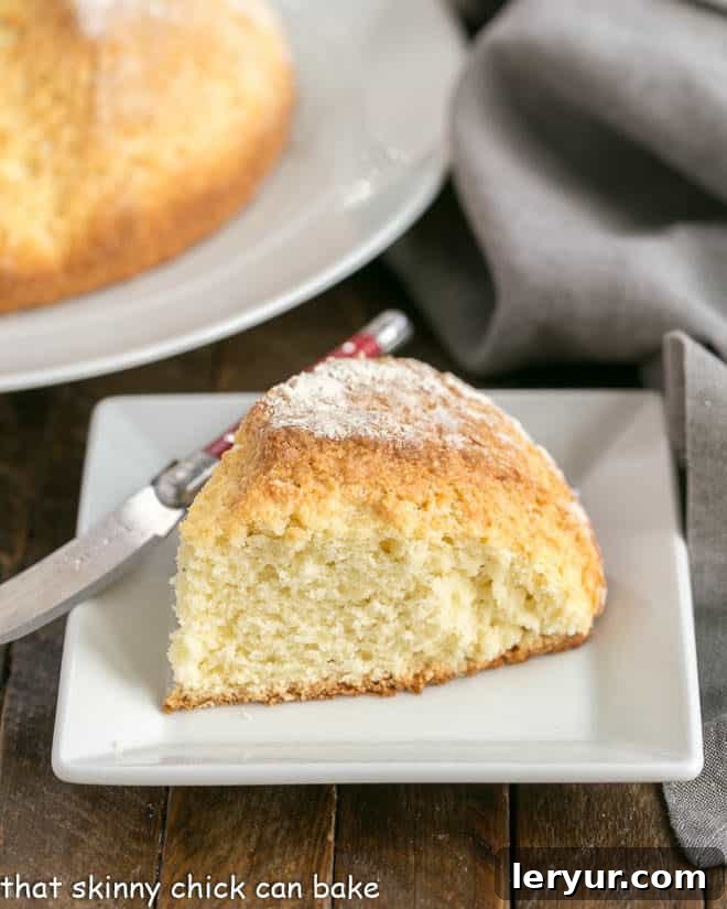 Easy Soda Bread - tender, sweet quick bread that will take you back to Ireland! A perfectly baked slice of Irish soda bread on a white ceramic plate, showcasing its tender crumb.