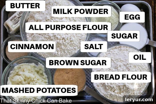 Grandma's Classic Cinnamon Buns 3 A sheet pan showcasing the individual ingredients for cinnamon rolls, neatly arranged with labels, emphasizing fresh, quality components.