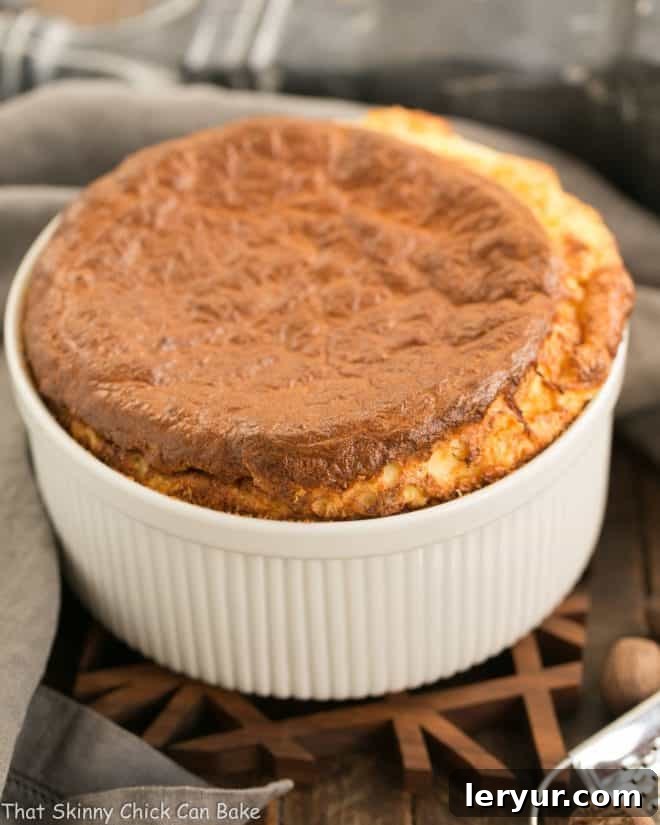 French Gruyere Souffle - a dreamy cheese souffle flavored with Swiss cheese, nutmeg and a pinch of cayenne Perfectly risen French Gruyere Souffle in a pristine white ceramic soufflé dish, ready to be served.
