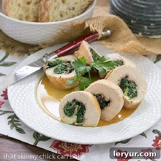 Elegant Chicken Pinwheels with Spinach and Prosciutto served on a white ceramic plate with a red accent knife, highlighting the savory layers.