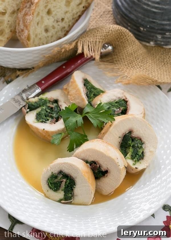 Close-up view of perfectly rolled Chicken Spinach and Prosciutto Pinwheels arranged neatly on a white plate, ready to be served.