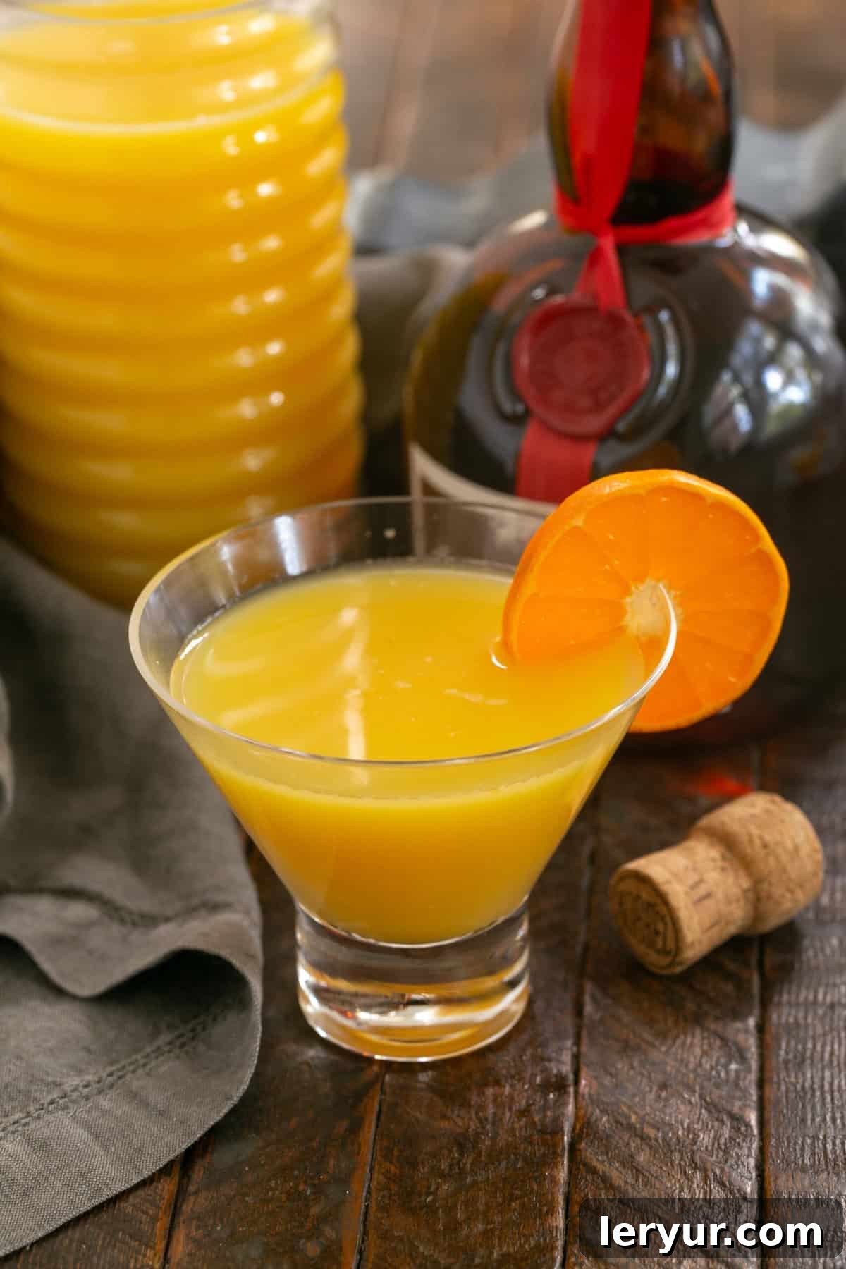 Elevated Grand Marnier Mimosas 5 A grand mimosa cocktail in a Viski glass with a clementine garnish on the rim, illustrating elegant presentation.