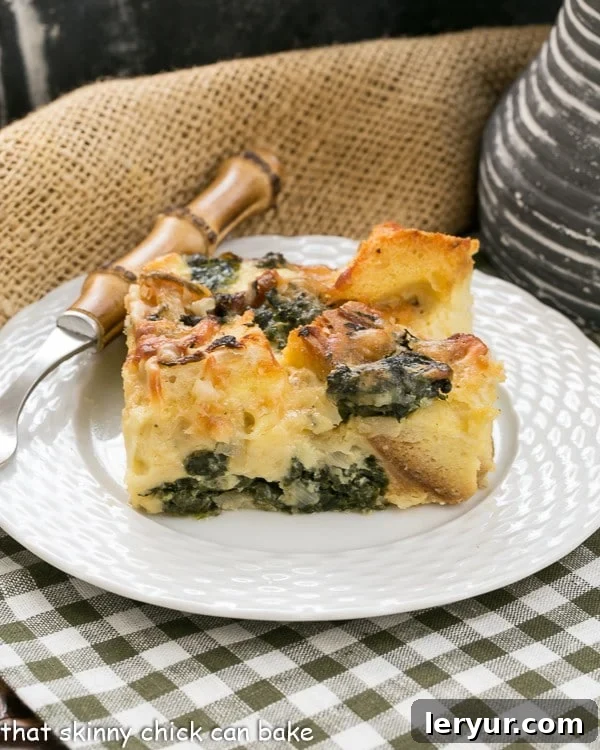 A square of spinach egg casserole on a small white plate on a green and white checked napkin.
