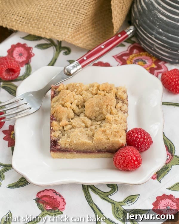 Close-up of a Raspberry Crumb Bar showing the layers and crumbly texture