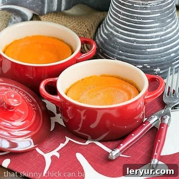 Carrot Puff - A lovely carrot souffle recipe for your vegetable course Two individual red terrines holding portions of fluffy Carrot Puff, showcasing its vibrant color.