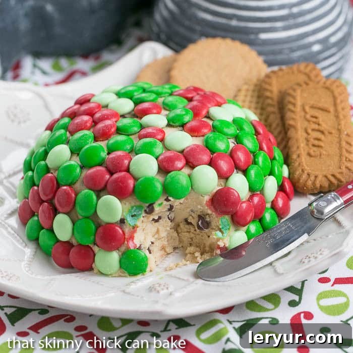 Cookie Dough Cheese Ball with a scoop removed, revealing the delicious, chocolate chip-studded interior.