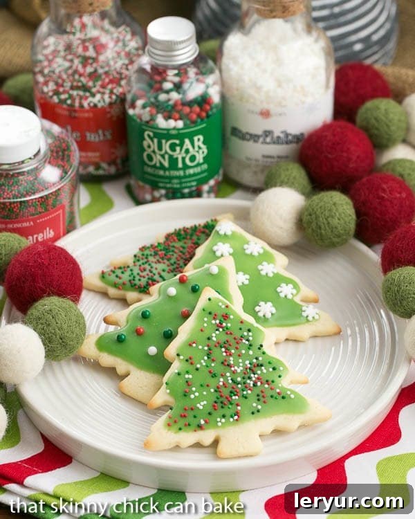 Easy Sugar Cookies - Perfect decorated sugar cookies for all holidays and celebrations A delightful plate of Easy Sugar Cookies, adorned with vibrant holiday frosting and festive sprinkles, creating a cheerful and inviting display.