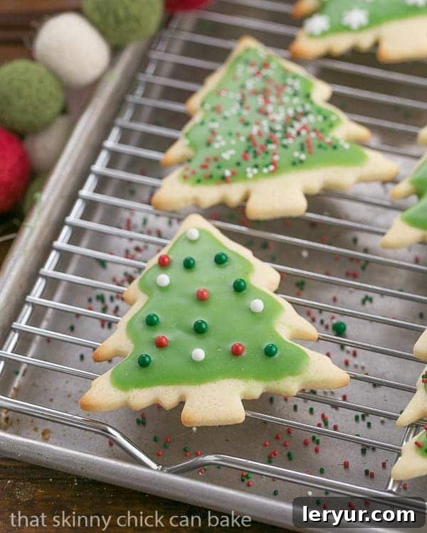 Easy Sugar Cookies - Perfect cut-out cookie recipe for all holidays and celebrations Freshly baked Homemade Sugar Cookies cooling on a wire rack, perfectly golden and ready for frosting.