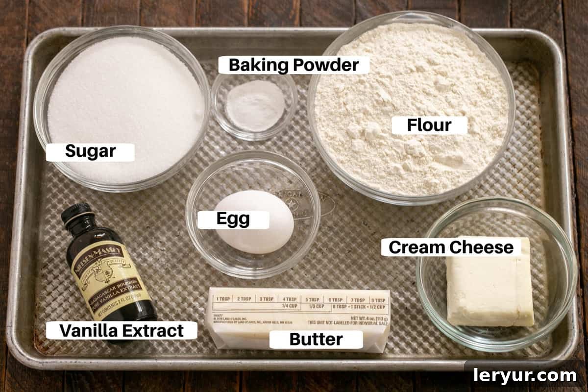 Whimsical Holiday Sugar Cookie Designs 3 A curated selection of Sugar Cookie Ingredients with clear labels, neatly arranged on a sleek metal sheet pan, ready for baking.