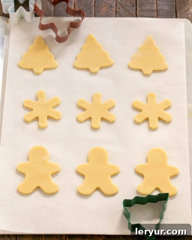 Whimsical Holiday Sugar Cookie Designs 9 Step 6: Use cookie cutters to create shapes and carefully transfer them to a prepared baking sheet.