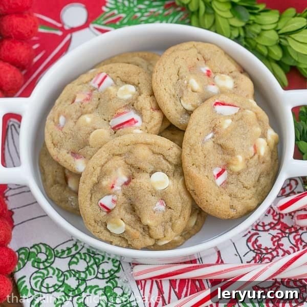 A festive spread of White Chocolate Candy Cane Cookies, neatly arranged to showcase their perfect round shape, and delicious white chocolate and peppermint bits. Ideal for holiday gifting or serving at Christmas parties.