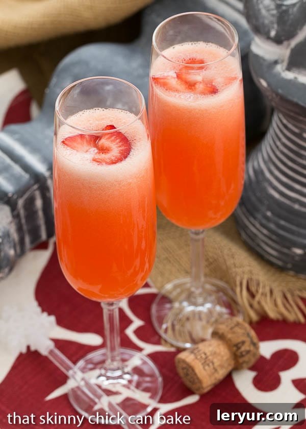 Peach Bellini cocktails in flutes with fresh strawberry slices, capturing a vintage feel.