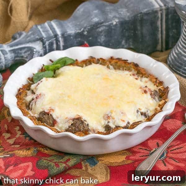A beautifully baked Italian Poutine Pie in a white ceramic pie plate, ready to be served.