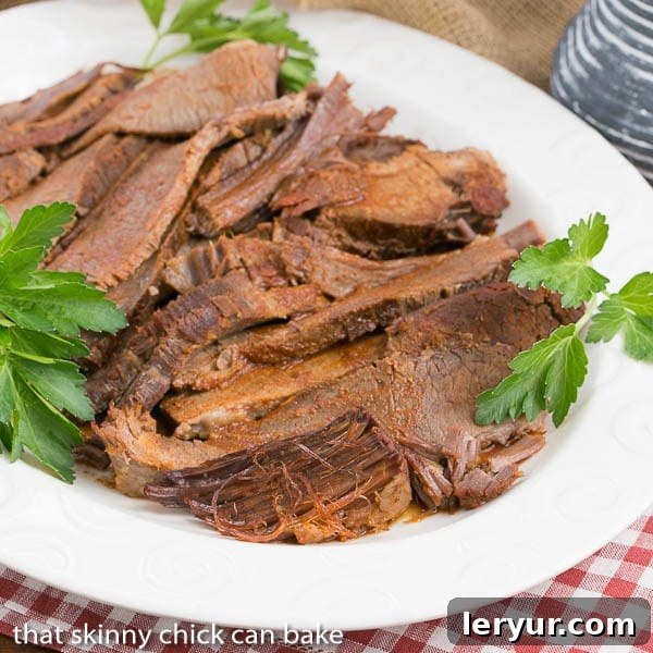 Texas brisket is typically a cut of beef that is smoked for a long time at a low temperature. When that's not possible, make this easy oven braised Texas brisket recipe for big, bold flavor in a juicy oven cooked beef brisket! slices of Oven Braised Texas Brisket on a white serving platter