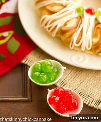 Overhead view of a tea roll and bowls of candied cherries, ready for baking