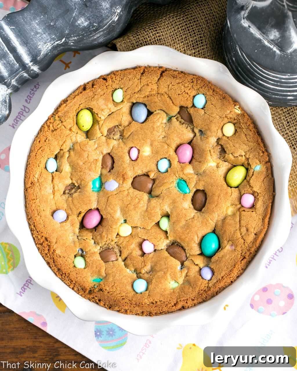 Overhead image of a large cookie cake studded with various types of Easter candy, showcasing its colorful appeal.