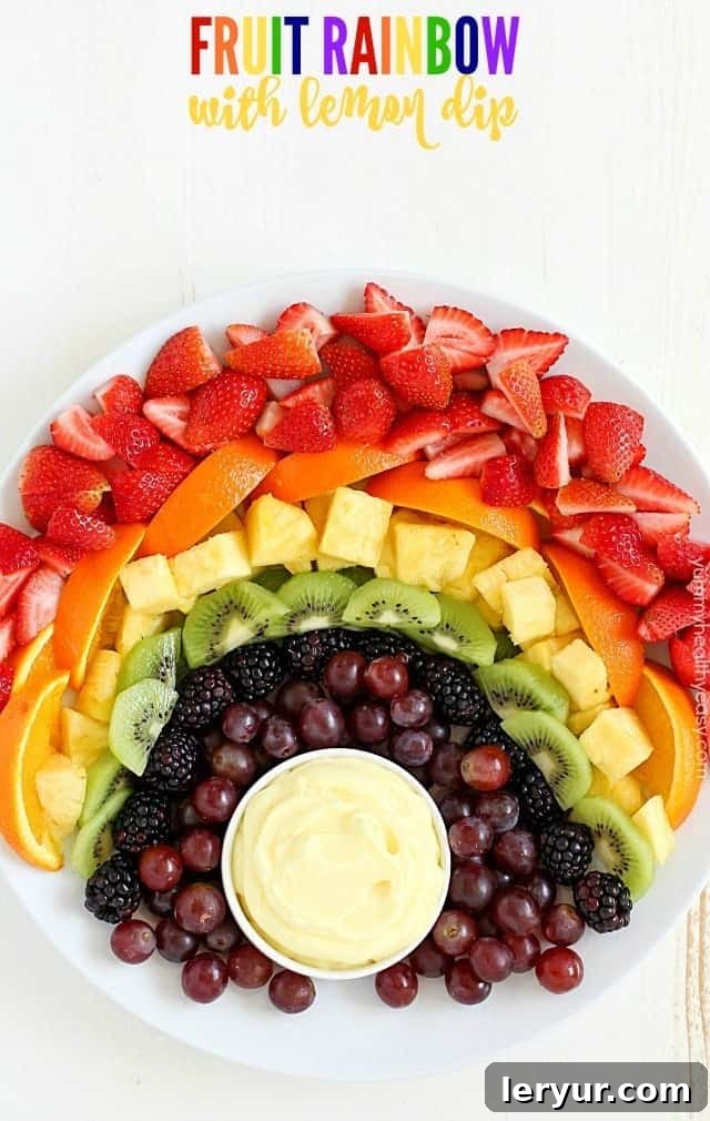 A colorful and healthy fruit rainbow platter served with a delicious, tangy lemon dip, perfect for spring entertaining and healthy snacking.
