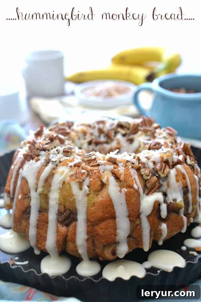 Scrumptious Hummingbird Monkey Bread, featuring pull-apart layers infused with coconut, bananas, and pineapple for an amazing breakfast or brunch treat.
