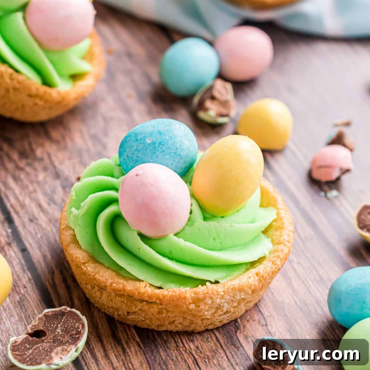 Sweet and soft Easter Sugar Cookie Cups, filled with creamy frosting and topped with festive Easter egg candies for a delightful seasonal dessert.
