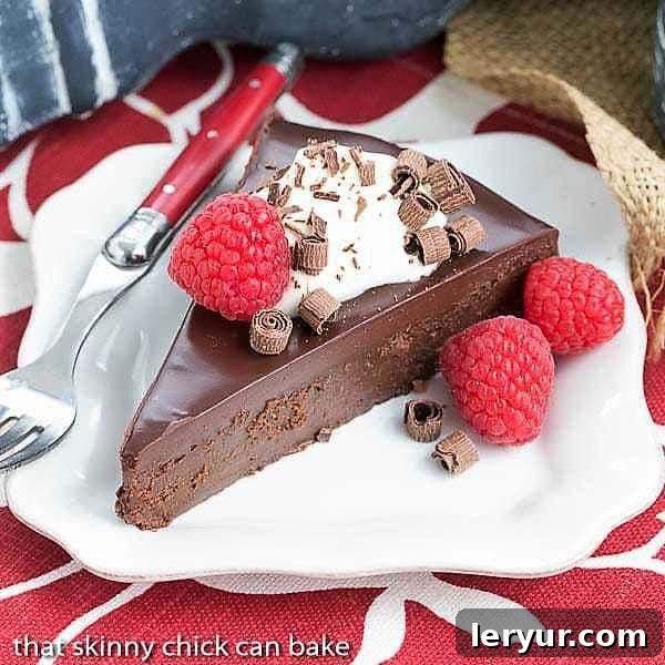 A rich, decadent slice of La Bete Noire on a white plate with a red handle fork.