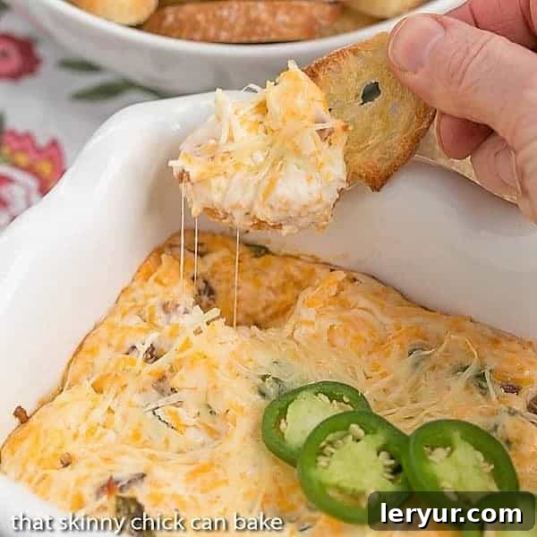 Jalapeno Popper Dip served warm on toasted crostini, garnished with green onions, a perfect cheesy, spicy bite for any gathering.