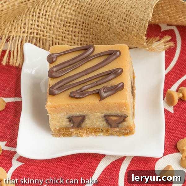 Peanut Butter Cheesecake Bars | Incredibly rich and filled with mini Reese's!