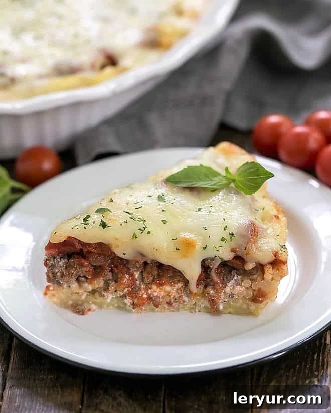 A close-up of a delectable slice of spaghetti pie, garnished with a fresh sprig of basil, resting elegantly on a pristine white plate.