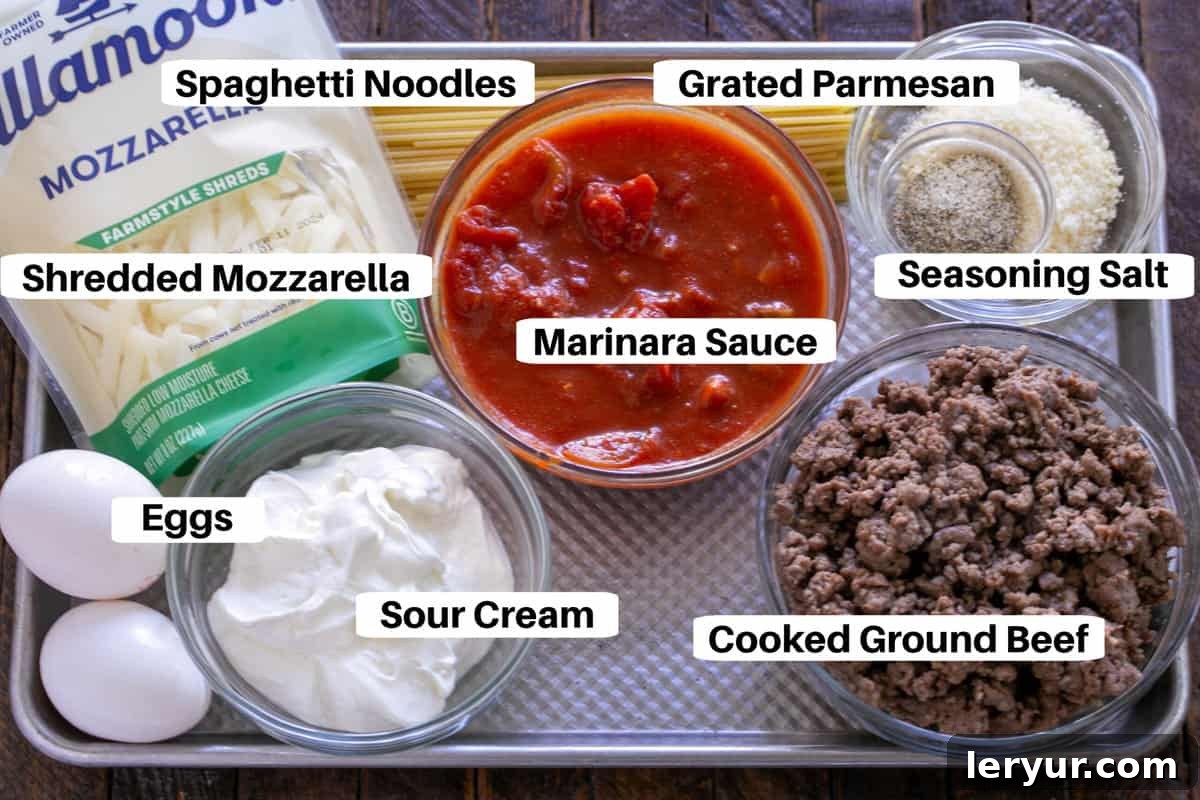 All the fresh ingredients laid out beautifully on a sheet pan, ready to be assembled into the ultimate spaghetti pie.