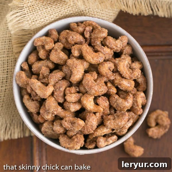Top-down view of a rustic wooden bowl filled to the brim with Spicy Sugared Cashews.