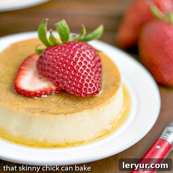 Mini Vanilla Flans - The classic Spanish custard and caramel dessert in individual servings! Mini Vanilla Flans topped with fresh strawberry slices, showcasing the rich caramel and creamy texture.