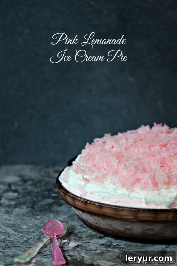 Refreshing Pink Lemonade Ice Cream Pie, vibrant and zesty, garnished with fresh lemon slices.