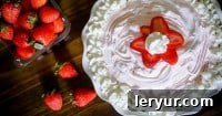 Creamy Frozen Strawberry Yogurt Pie with a crumbly crust, sliced and ready to enjoy.