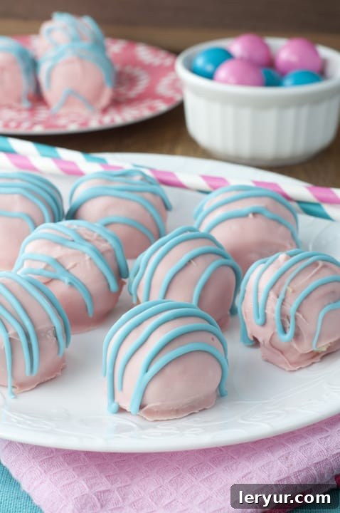 Pink and white Cotton Candy Oreo Truffles on a plate, looking whimsical and sweet.