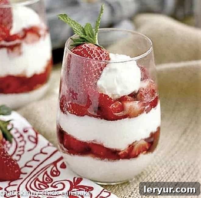 Beautiful Strawberry Cheesecake Parfaits in elegant glasses, showing layers of creamy cheesecake and fresh strawberries.
