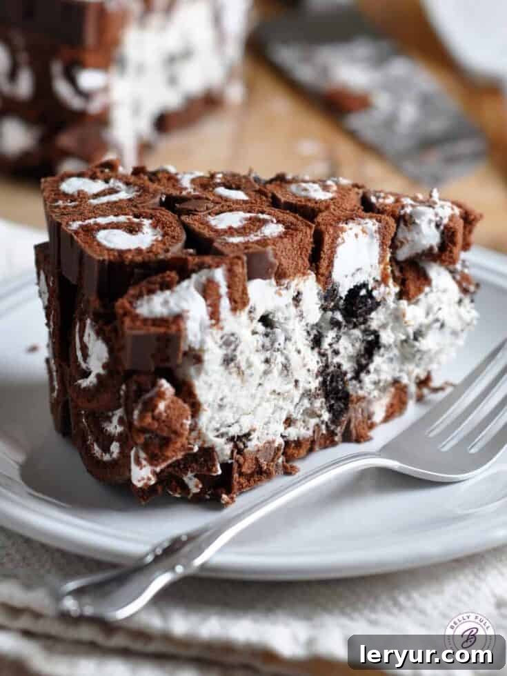 Decadent No-Bake Cookies and Cream Swiss Roll Cake, topped with chocolate sauce and cookie crumbles.