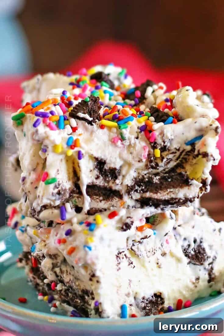 Festive Cake Batter Oreo Cheesecake Dessert with colorful sprinkles, showing a delightful cross-section.
