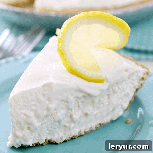 Refreshing Frozen Lemonade Pie, garnished with fresh lemon slices and zest, perfectly chilled.