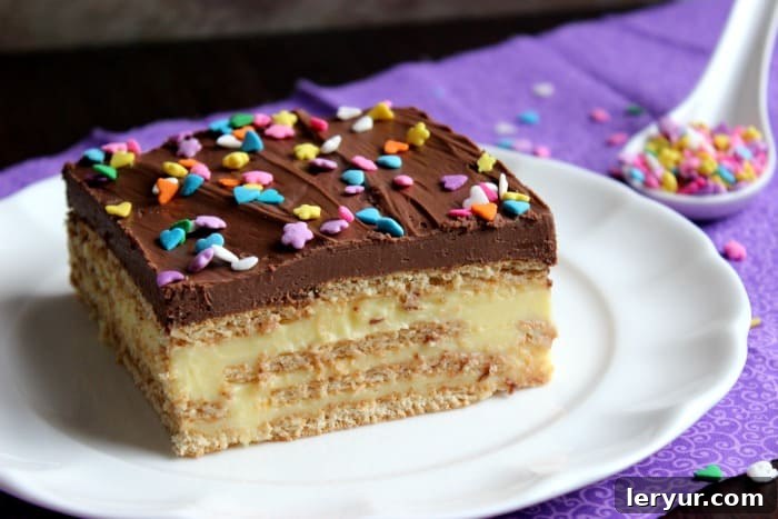 Decadent Chocolate Eclair Dessert with layers of graham crackers, creamy filling, and a rich chocolate frosting.