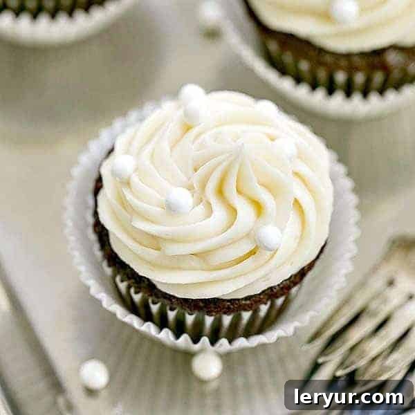 Vanilla Buttercream Topped Cocoa Cupcakes | Moist, scrumptious chocolate cupcakes topped with a mound of vanilla buttercream