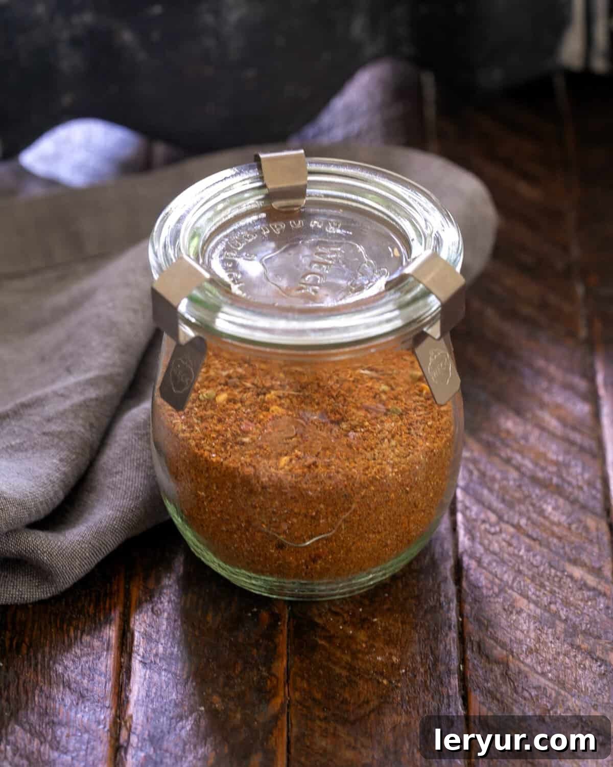 Taco seasoning in a glass storage container.
