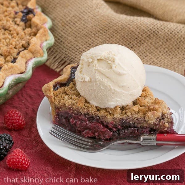 Berry Bliss: 50+ Irresistible Dessert Ideas 12 A delicious Razzleberry Pie, featuring a vibrant filling of raspberries, blackberries, and blueberries, topped with a golden crumb.