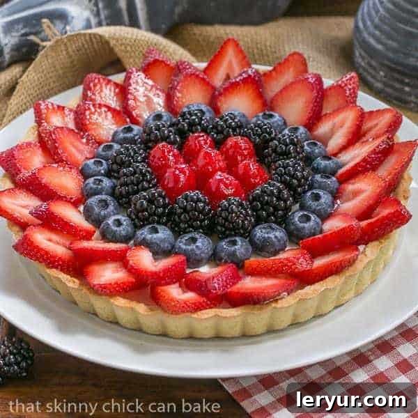 Berry Bliss: 50+ Irresistible Dessert Ideas 14 A stunning Summer Fruit Tart, featuring a golden pastry crust, creamy filling, and a beautiful arrangement of summer berries.