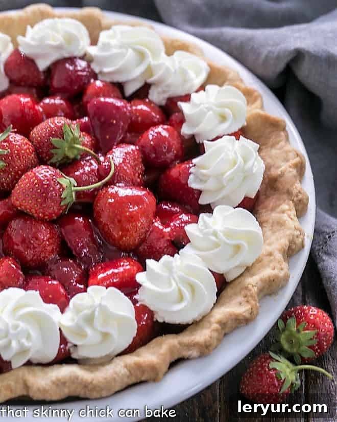 Berry Bliss: 50+ Irresistible Dessert Ideas 7 A classic Fresh Strawberry Pie, brimming with whole strawberries, set in a golden crust, ready to be served.
